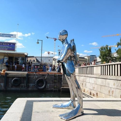 scuba diver statue stainless steel art on the bank